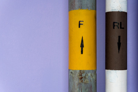 Pipes with arrow signage forward & reward on purple color wallの写真素材