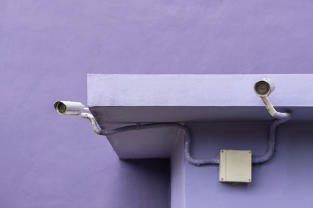 CCTV on purple color wall under operationの写真素材