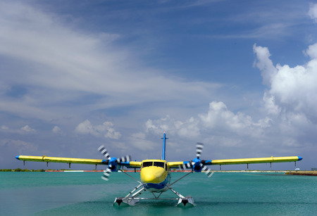 Yellow seaplane is taking off at the airport in Maldivesの写真素材