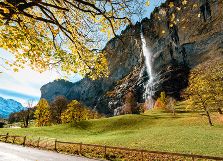 Beautiful autumn time at village of Lauterbrunnen in Swiss alps, gateway to famous Jungfrau. Set in a valley featuring rocky cliffs and the roaring, 300m-Â­high Staubbach Fallsの写真素材