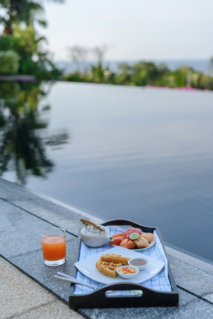 Breakfast tray by the swimming poolの写真素材