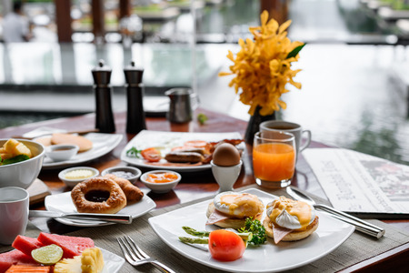 Setting of breakfast dishes in hotel restaurantの写真素材