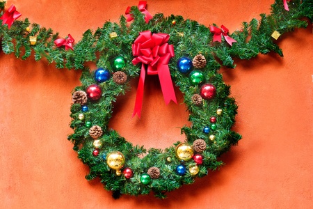 Christmas wreath on orange background with copyspaceの写真素材