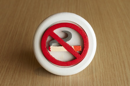 No Smoking Sign on wood table in restaurant with text spaceの写真素材