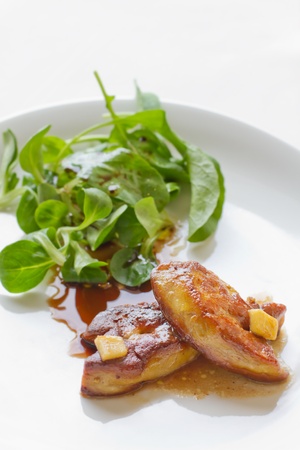 foie gras with salad on white plateの写真素材