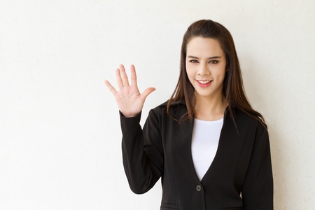 woman business executive showing 5 or five fingers hand gestureの写真素材
