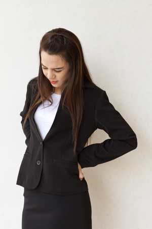backpain of female business executive, concept of office syndrome with spinal or lower back problemの写真素材