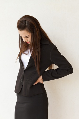 backpain of female business executive, concept of office syndrome with spinal or lower back problemの写真素材