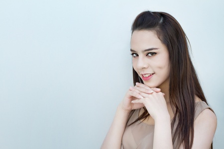 smiling beautiful female with positive attitude on plain cooltone background with textspaceの写真素材