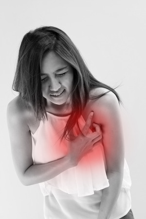 sick woman with heart attack, chest pain, health problem with red alert accentの写真素材