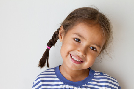 portrait of happy, positive, smiling, playful asian caucasian girlの写真素材