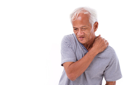 old man suffering from shoulder muscle inflammation or injuryの写真素材