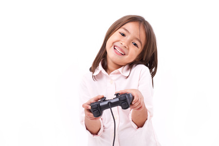 Happy little girl gamer playing video gameの写真素材