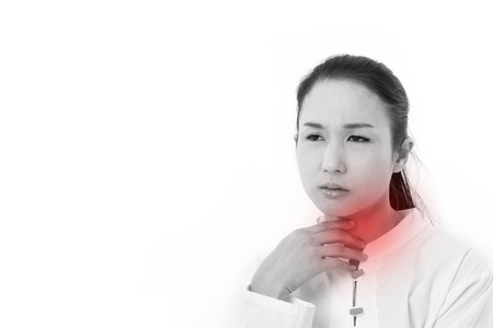 sick woman suffers from sore throat or reflux, with red alert accentの写真素材