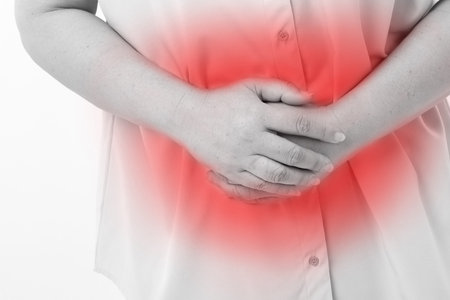 middle aged woman suffering from stomach ache, belly pain, menstuation, menopause, indigestion...
