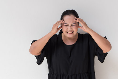 middle age woman suffering from headache, stress, tension, migraine, insomnia, painの写真素材