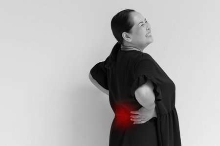 woman suffering from back pain, spinal injury, muscle issue problemの写真素材