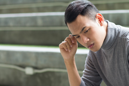 thinking asian man portraitの写真素材