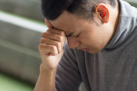 sick asian man having headache, stressの写真素材