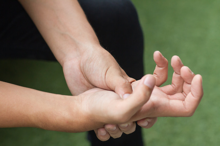 man suffering from trigger finger, arthritis, wrist painの写真素材
