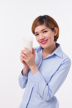 healthy asian woman holding glass of milkの写真素材