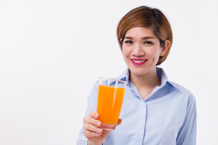 healthy asian woman holding glass of orange juiceの写真素材