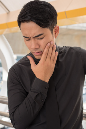 man suffering from toothache, oral problemの写真素材