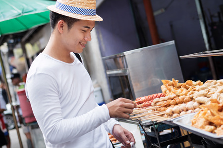 man traveller enjoying asian thailand street foodの写真素材