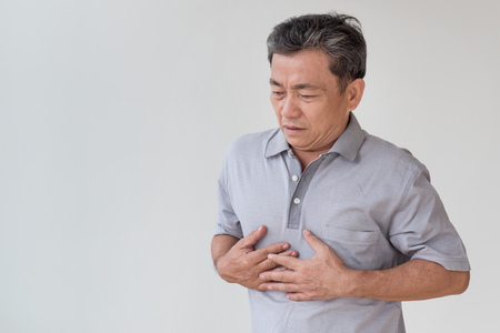 sick old man acid reflux, heartburn, heart attackの写真素材