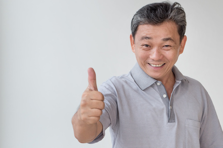 happy, successful, positive middle aged man showing thumb upの写真素材