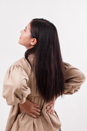 woman suffering from back pain, backbone or spinal muscle injuryの写真素材