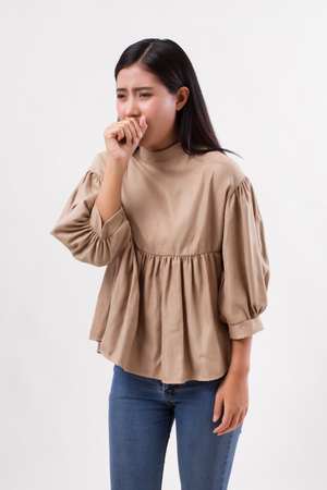 sick woman coughing with cold or sore throatの写真素材