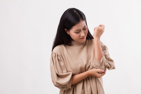 woman suffering from elbow joint pain, rheumatoid or gout arthritisの写真素材