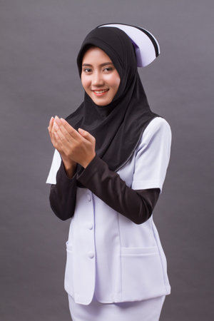 Asian muslim nurse praying, prayer hand gesture