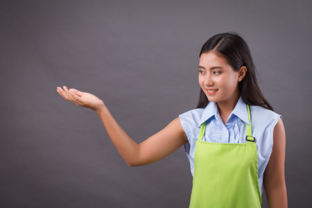 woman worker hand up holding something on blank spaceの写真素材