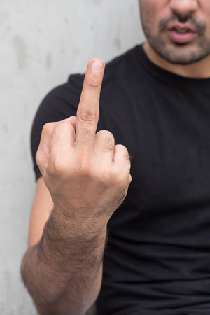 Angry man giving middle finger