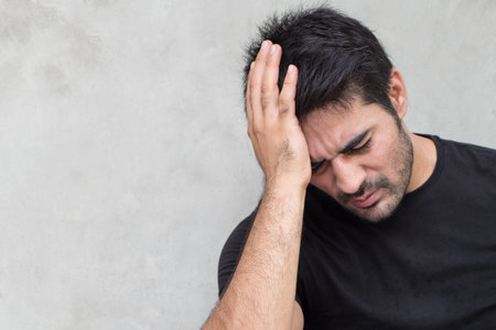 asian man suffering from headache, vertigo, hangover, migraine, stress
