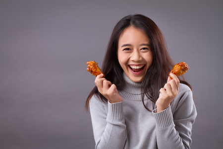 happy woman with fried chickenの写真素材