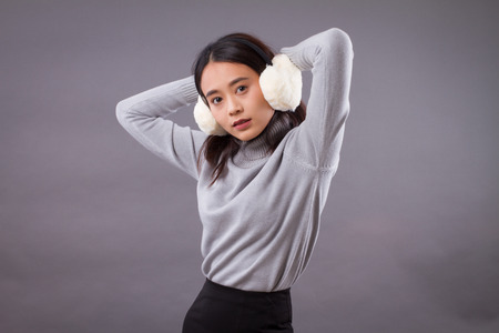 portrait of asian woman with earmuffsの写真素材
