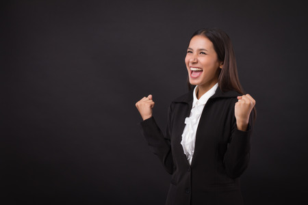 happy, successful, confident businesswoman looking up shouting, communication, announcingの写真素材