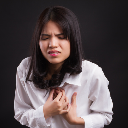 sick stressed woman with acid reflux, gerd symptomsの写真素材