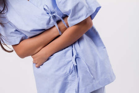 Woman with a stomach ache, menstrual period cramp, abdominal pain, food poisoningの写真素材