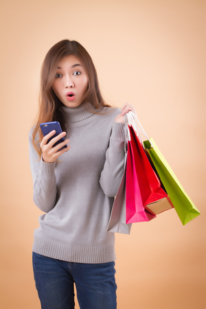 woman shopper shopping with smart phone applicationの写真素材