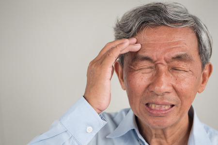 senior old man suffering from sharp acute headache pain, migraine, stress, hangoverの写真素材