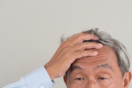 worried retired senior old man with grey hair aging problemの写真素材