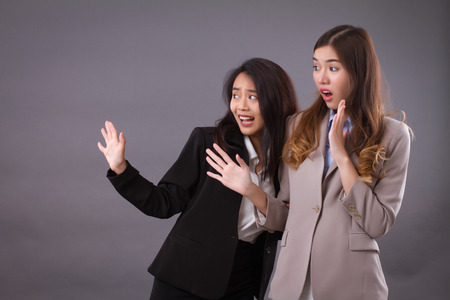 scared worried business women team facing problemの写真素材