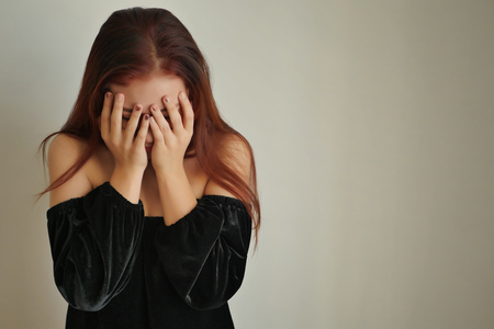 stressed woman doing facepalm gestureの写真素材