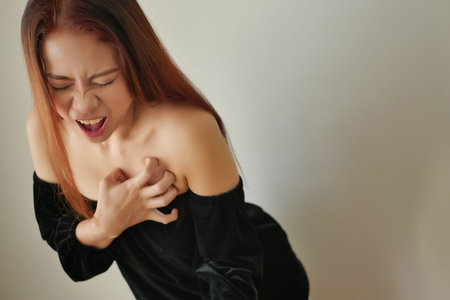 woman suffering from acute heart attack