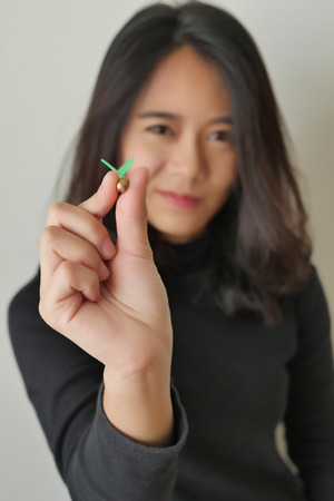 woman aiming dart, concept of target or goalの写真素材
