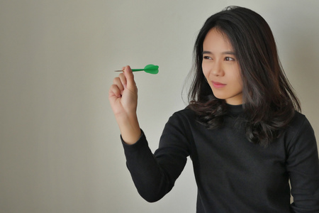 woman aiming dart, concept of target or goalの写真素材